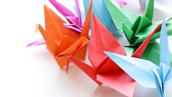 Folded Peace Cranes in red, blue, orange, green, and purple.