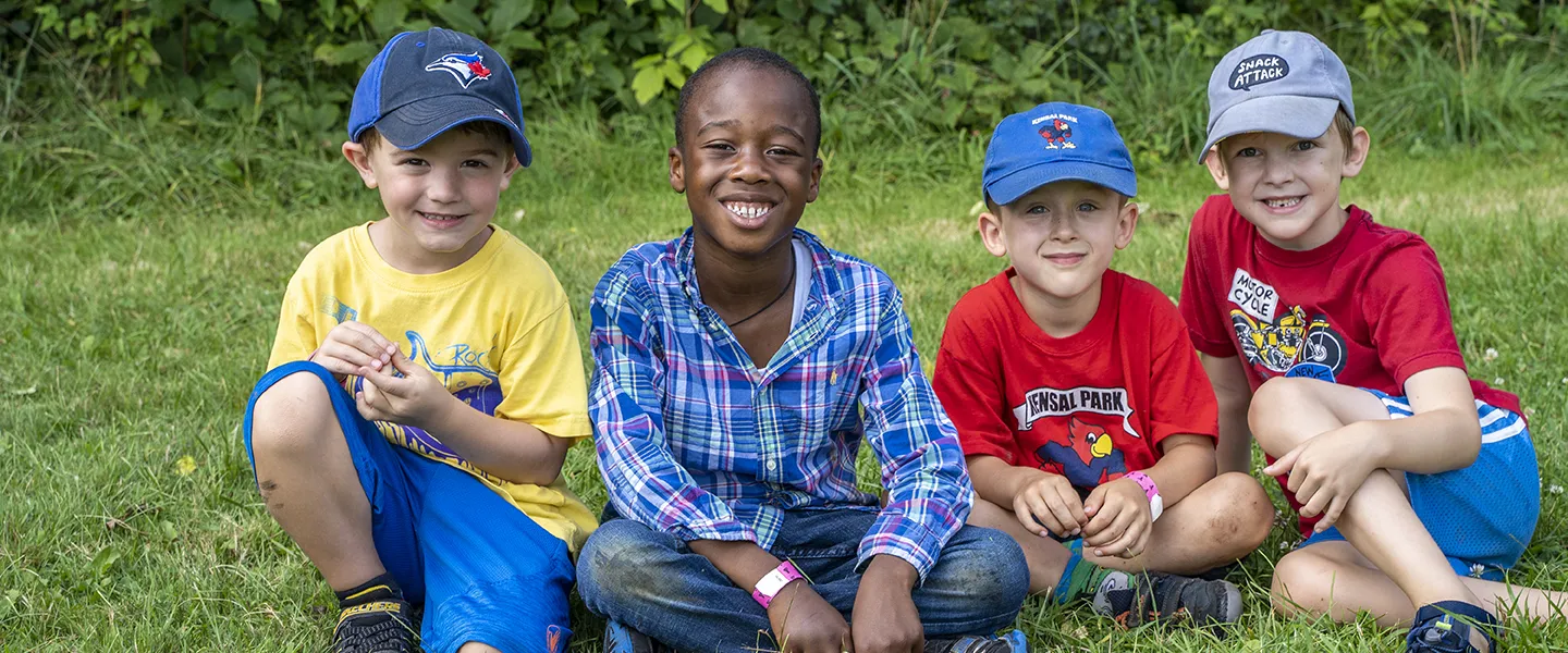 Boys sitting on the lawn during Summer Camp