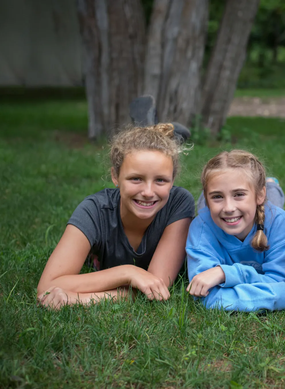 3 young women enjoying the grass.