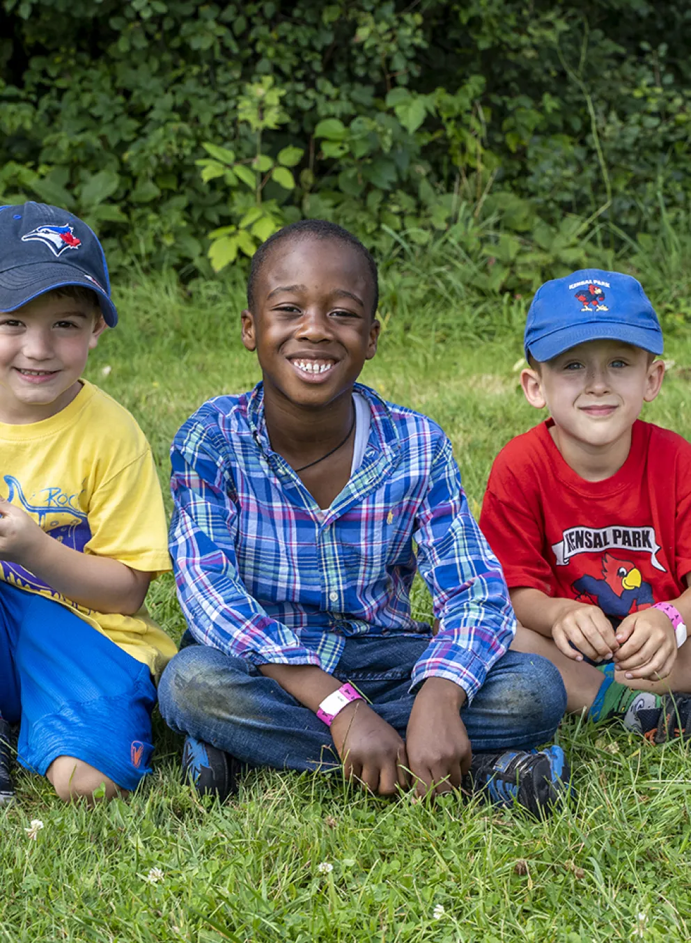 Boys sitting on the lawn during Summer Camp