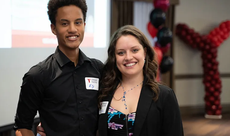 Two young staff members attend the YMCA's Annual Community Gathering.