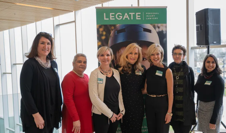 Seven of the 2019 Women of Excellence pose at a media event.