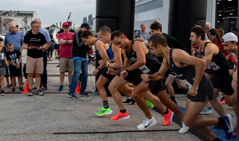 A group of men in colourful shoes get into starting position for Jordan's Run.