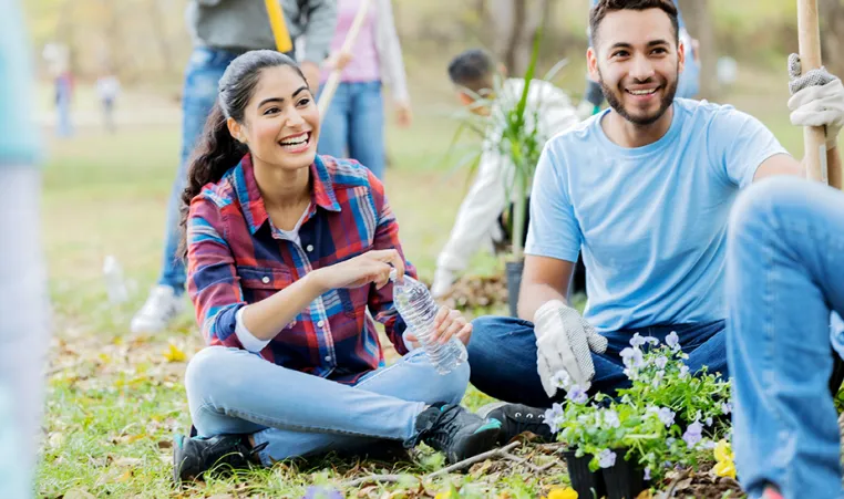 Man and Women helping plant a community garden