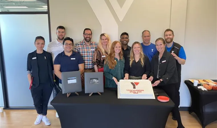 People celebrating around a cake