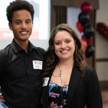 Two young staff members attend the YMCA's Annual Community Gathering.