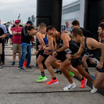 A group of men in colourful shoes get into starting position for Jordan's Run.