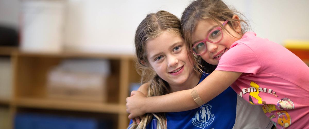 Sisters hugging while at after care